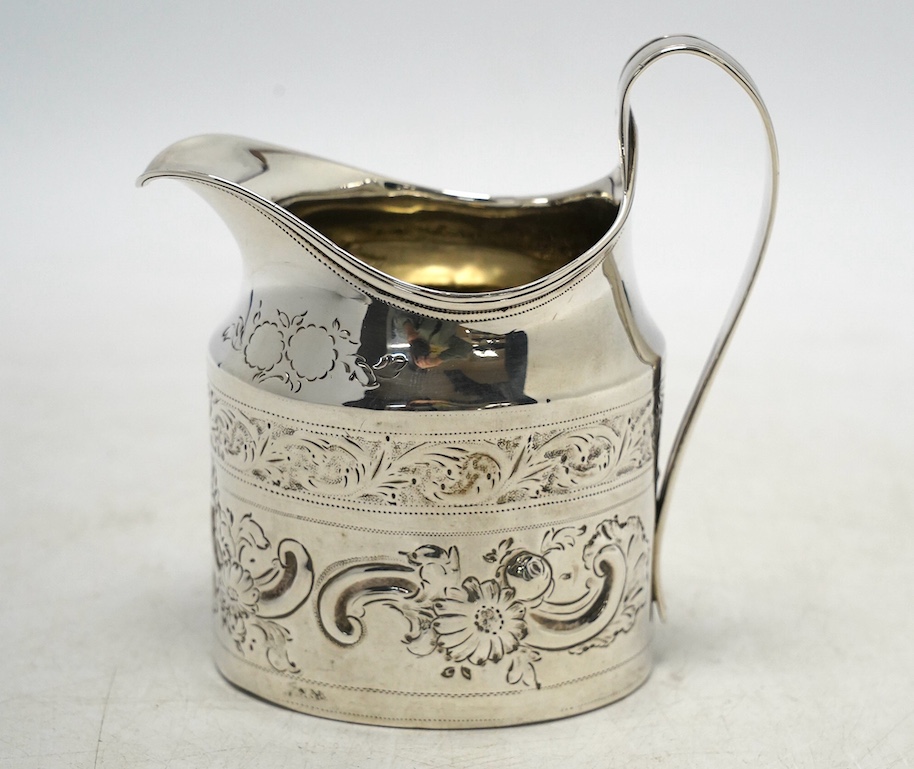 A George III silver cream jug, with later decoration, Robert & David Hennell, London, 1796, 10.4cm, 3.5oz. Condition - poor to fair